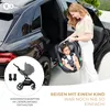 A woman is placing a baby car seat into a car. Náhled obrázku produktu