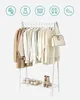 A white metal garment rack with clothes and accessories displayed. Produktbild-Vorschau