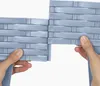 Hands assembling two grey plastic garden edging pieces with a rattan-like texture. Produktbild-Vorschau