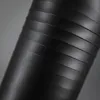 A close-up, angled view of a black ribbed cylinder, likely a water bottle. Produktbild-Vorschau