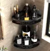 Two black corner shelves are mounted on a tiled wall, holding various bathroom products. Náhľad obrázku produktu