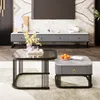 A living room scene featuring two coffee tables in the foreground, a TV stand with a TV above it in the background, and decorative elements. Voir les images du produit