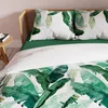 A close-up view of a bed with green and white banana leaf patterned bedding. Podgląd zdjęcia produktu