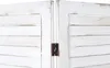 A close-up view of the hinge connecting two panels of a white wooden room divider. Produktbild-Vorschau