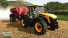 A yellow and black tractor is shown in a field, pulling a red fertilizer spreader. The tractor is in motion, kicking up dust. Produktbild-Vorschau