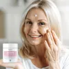 A woman is applying cream to her face, holding a jar of the product. Produktbild-Vorschau