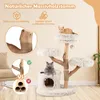A cat tree with two cats, positioned in a room setting with furniture and plants. Voir les images du produit
