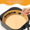 A hand is shown placing a magnetic clip onto the edge of a paper liner inside an air fryer basket, which contains a cake batter. Produktbild-Vorschau