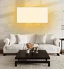 A living room scene with a sofa, coffee table, and a wall-mounted heater. Produktbild-Vorschau