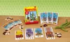 A board game box and cards are laid out on a wooden table, along with some beans and green beans. Anteprima dell’immagine prodotto