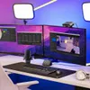 A streaming or content creation setup with multiple monitors, a microphone, and lighting. Produktbild-Vorschau