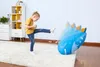 A young girl is kicking a blue inflatable bop bag in a room. Produktbild-Vorschau