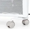 A close-up view of the bottom part of a white electric heater, showing its base and two wheels. Náhľad obrázku produktu