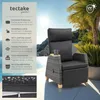 A recliner chair with a side table and cup on a patio with a tropical background. Náhled obrázku produktu