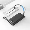 A black power bank is charging from a multi-port USB hub, with a blue charging indicator arrow. Anteprima dell’immagine prodotto
