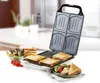 A sandwich maker with toasted sandwiches and a salad on a table. Produktbild-Vorschau