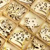 A close-up view of wooden Christmas tree ornaments in a wooden box, with a golden string of lights woven through them. Produktbild-Vorschau