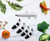 A collection of kitchen appliance parts and fresh vegetables arranged on a marble-like surface. Anteprima dell’immagine prodotto