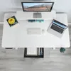 A top-down view of a white standing desk with a monitor, laptop, keyboard, mouse, and a book. Anteprima dell’immagine prodotto