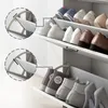 A white shoe cabinet with multiple shelves and drawers, displaying various types of shoes. Produktbild-Vorschau