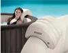 A woman relaxing in an Intex PureSpa hot tub, with a close-up of the headrest in the foreground. Produktbild-Vorschau