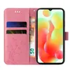 A pink floral and butterfly patterned flip case for a smartphone, with credit cards and a banknote inserted. Produktbild-Vorschau