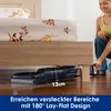 A woman is using a vacuum cleaner under a bed. Podgląd zdjęcia produktu