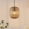 A pendant light with a rattan shade hangs against a light-colored wall. Produktbild-Vorschau