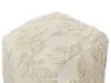 A close-up view of a beige pouf with a textured leaf pattern. Produktbild-Vorschau