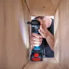 A person is using a Bosch cordless drill inside a wooden structure. Náhled obrázku produktu