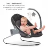 A baby is sitting in a gray Hauck Alpha Bouncer Deluxe baby bouncer with toys hanging from a mobile. Produktbild-Vorschau