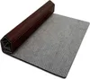 A rolled-up mat with a brown wooden casing on a white background. Anteprima dell’immagine prodotto