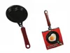 Two heart-shaped frying pans are shown against a white background. One pan is shown on its own, and the other is shown with its packaging, which includes an image of a fried egg in the pan. Náhľad obrázku produktu