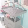 A baby changing station with toys and a quilted mat. Produktbild-Vorschau