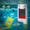A radiation detector is shown in a polluted ocean environment with radioactive barrels and mutated fish. Produktbild-Vorschau