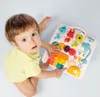 A baby is playing with a colorful interactive toy table. Podgląd zdjęcia produktu