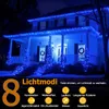 A house decorated with blue string lights at night. Produktbild-Vorschau