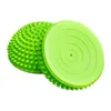 Two green balance pods are shown against a white background. One pod is shown from the side with its spiky surface visible, and the other is shown from the top with its flat, circular surface facing upwards. Podgląd zdjęcia produktu