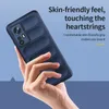A hand holding a dark blue phone case against a blue background. Produktbild-Vorschau