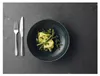 A plate of pasta with asparagus and cutlery on a dark stone surface. Produktbild-Vorschau