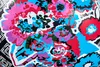 A close-up view of a colorful floral pattern with abstract shapes. Produktbild-Vorschau