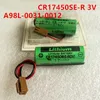 Two green lithium batteries with wires and connectors are shown on a light gray surface. Náhled obrázku produktu