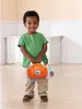 A young boy is holding a toy laptop in a room. Produktbild-Vorschau
