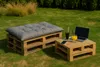 A pallet sofa and table set with drinks and a laptop on a grassy lawn. Produktbild-Vorschau