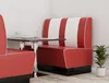 A diner booth with red and white striped upholstery, next to a small table with a glass and bowl. Produktbild-Vorschau