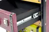 Close-up of an open drawer in a multi-colored storage unit designed to look like suitcases. Podgląd zdjęcia produktu