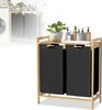 A laundry basket with two compartments and a shelf on top, placed in a laundry room setting. Náhled obrázku produktu