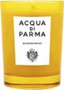 A yellow candle in a glass container with a white label. Produktbild-Vorschau