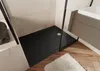 A modern bathroom with a black shower tray, a white sink and vanity, and wooden flooring. Anteprima dell’immagine prodotto