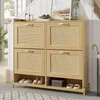 A wooden shoe cabinet with rattan doors and a metal frame, placed in an entryway or hallway.